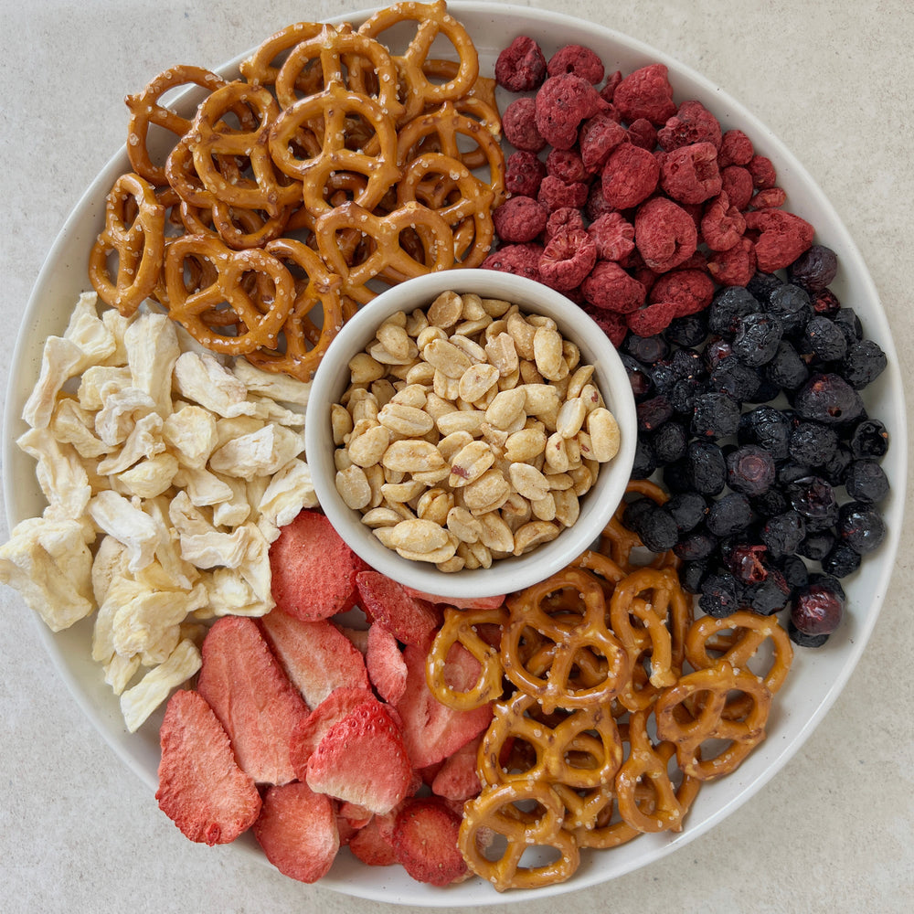 Snack tray of freeze-dried fruits with pretzels and peanuts