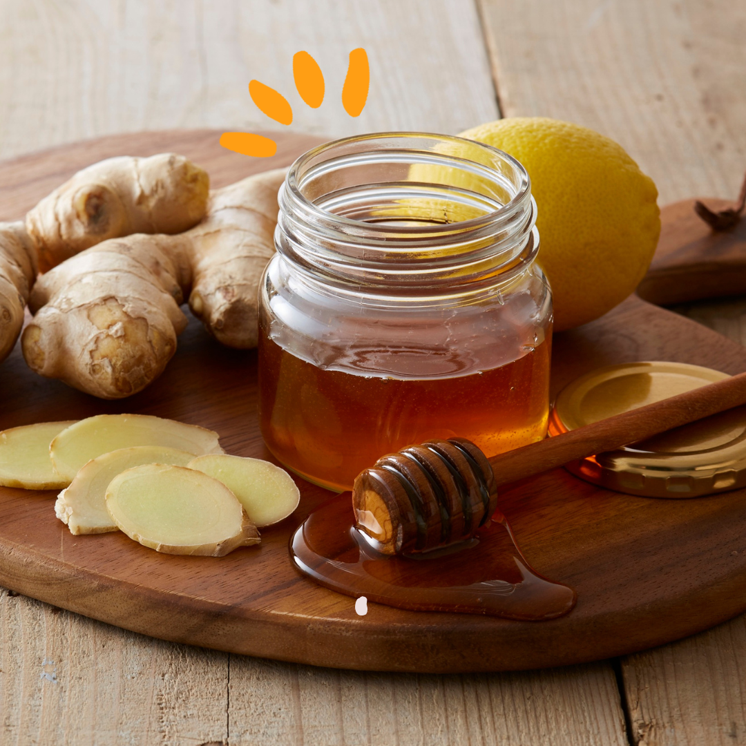 jar of honey next to cut ginger