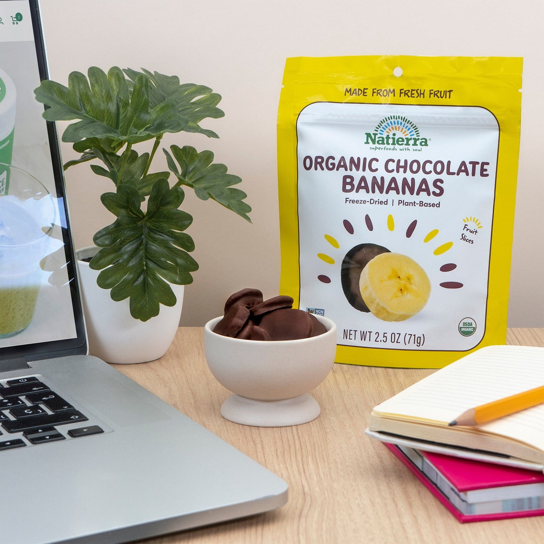 Natierra Organic Chocolate Covered Bananas on an office desk with office accessories