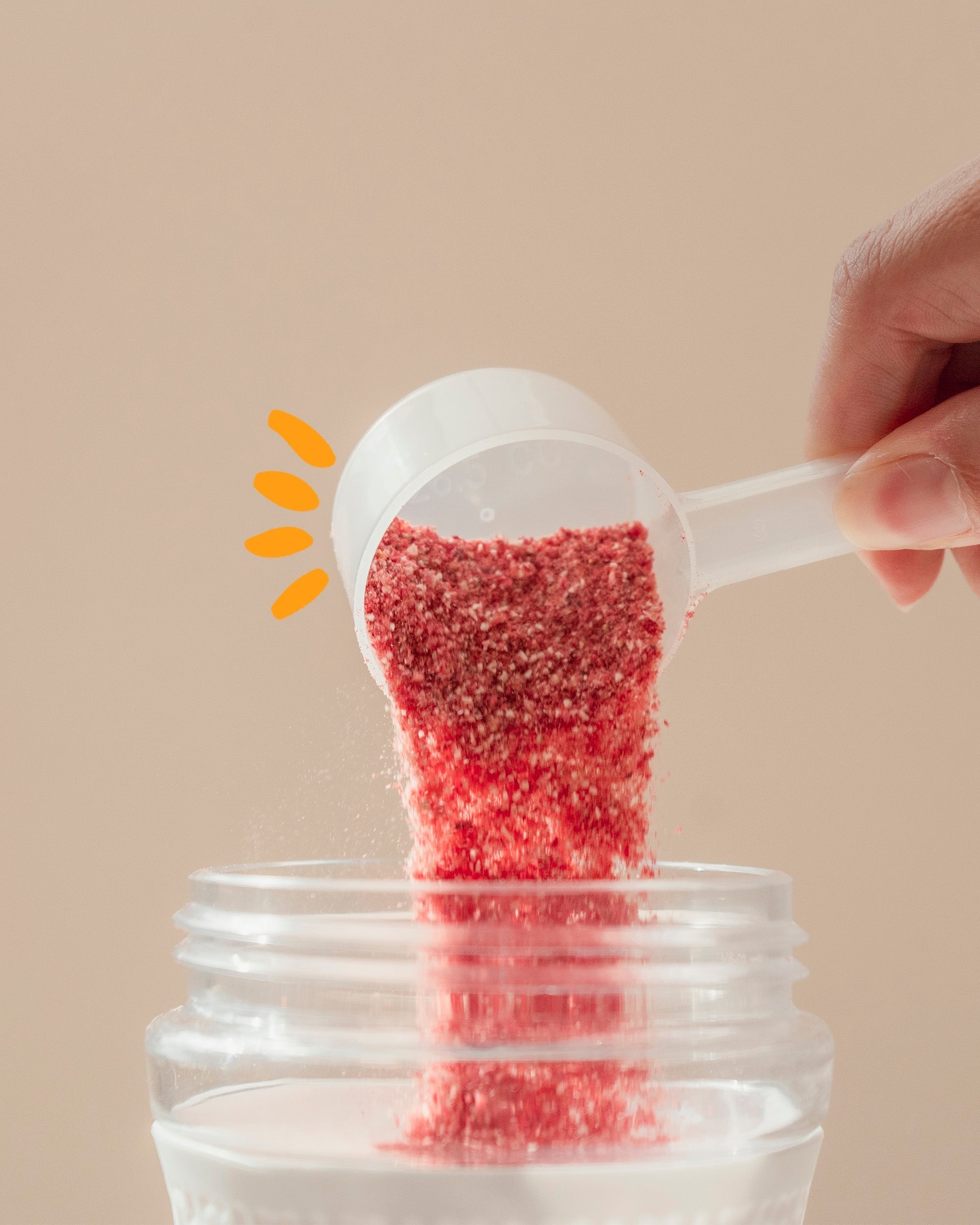 Organic strawberry smoothie powder pouring unto shaker