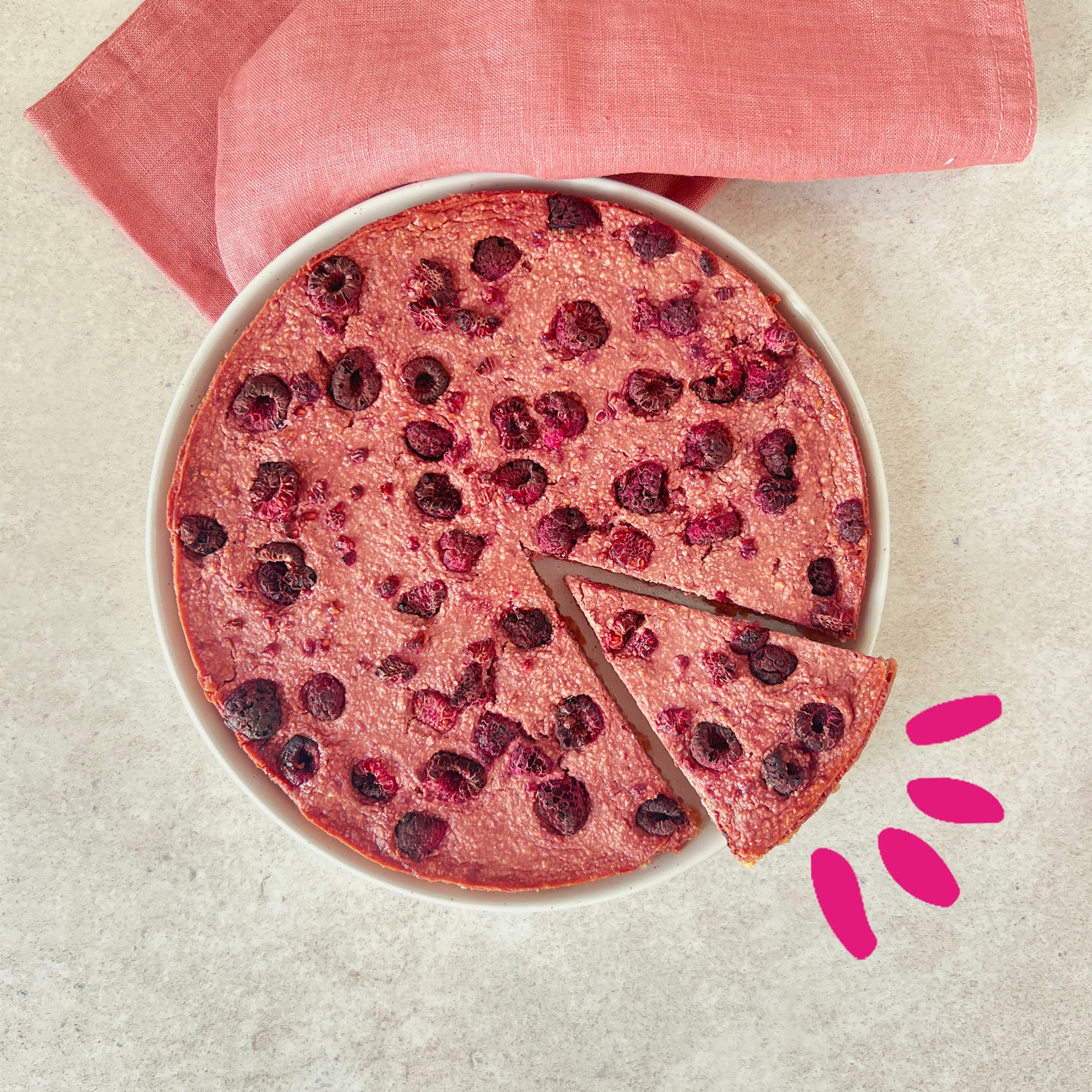 Raspberry cheescake in a plate on a clear surface