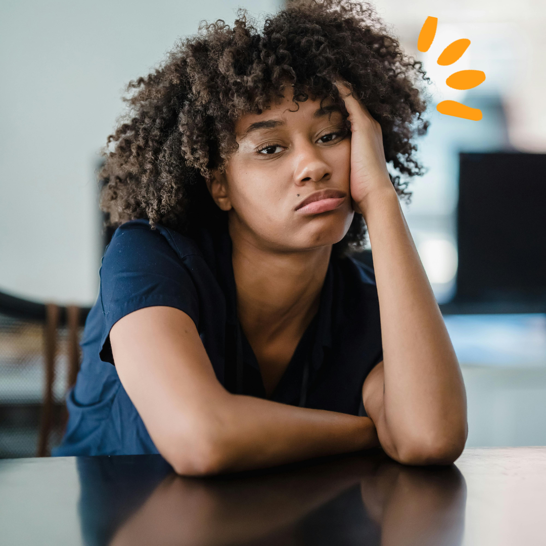 A women sitting and looking bored