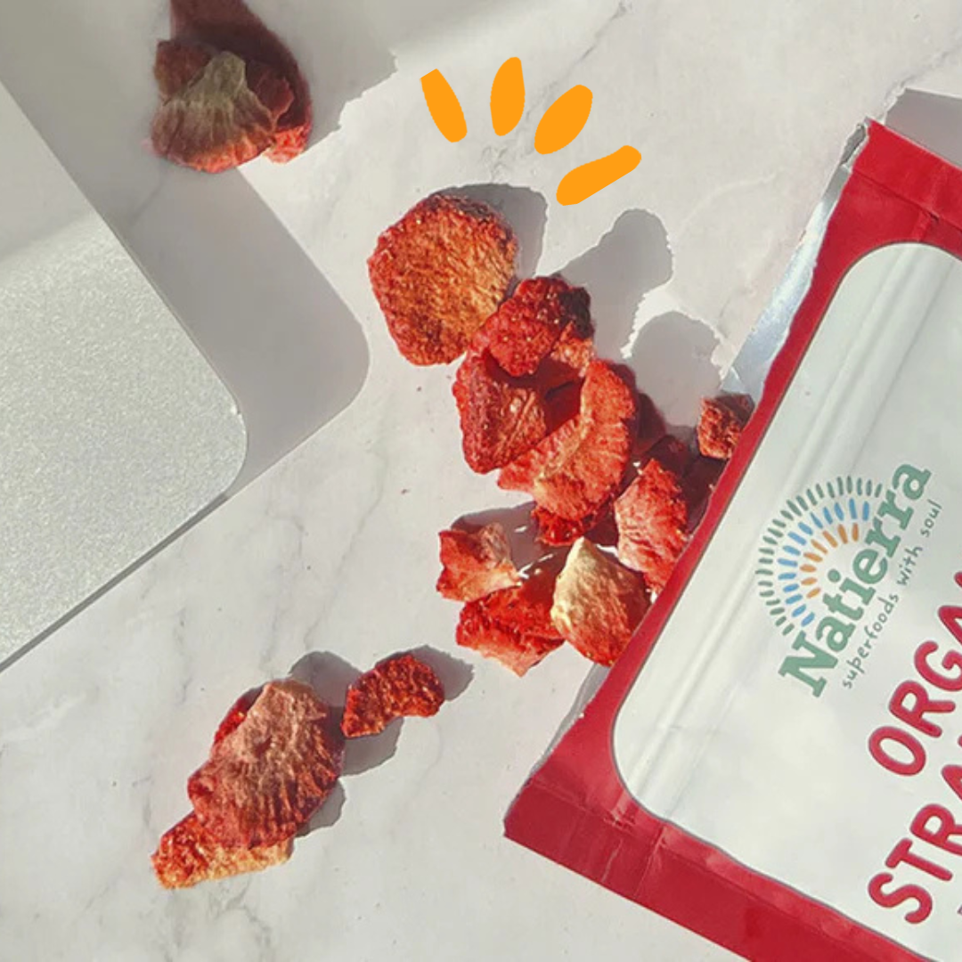Freeze-dried strawberries out of the bag next to a laptop