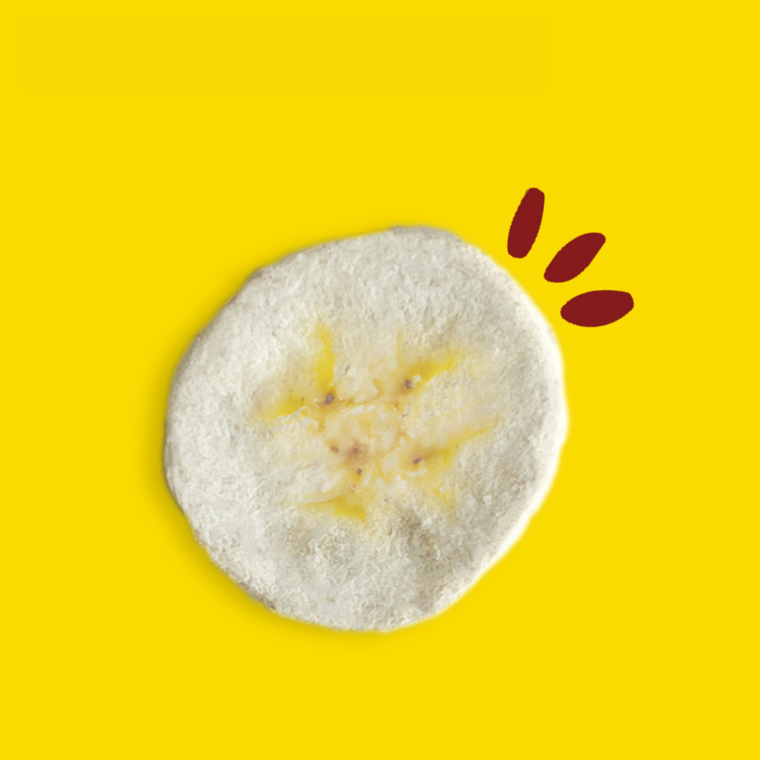 Piece of freeze-dried banana against a yellow background