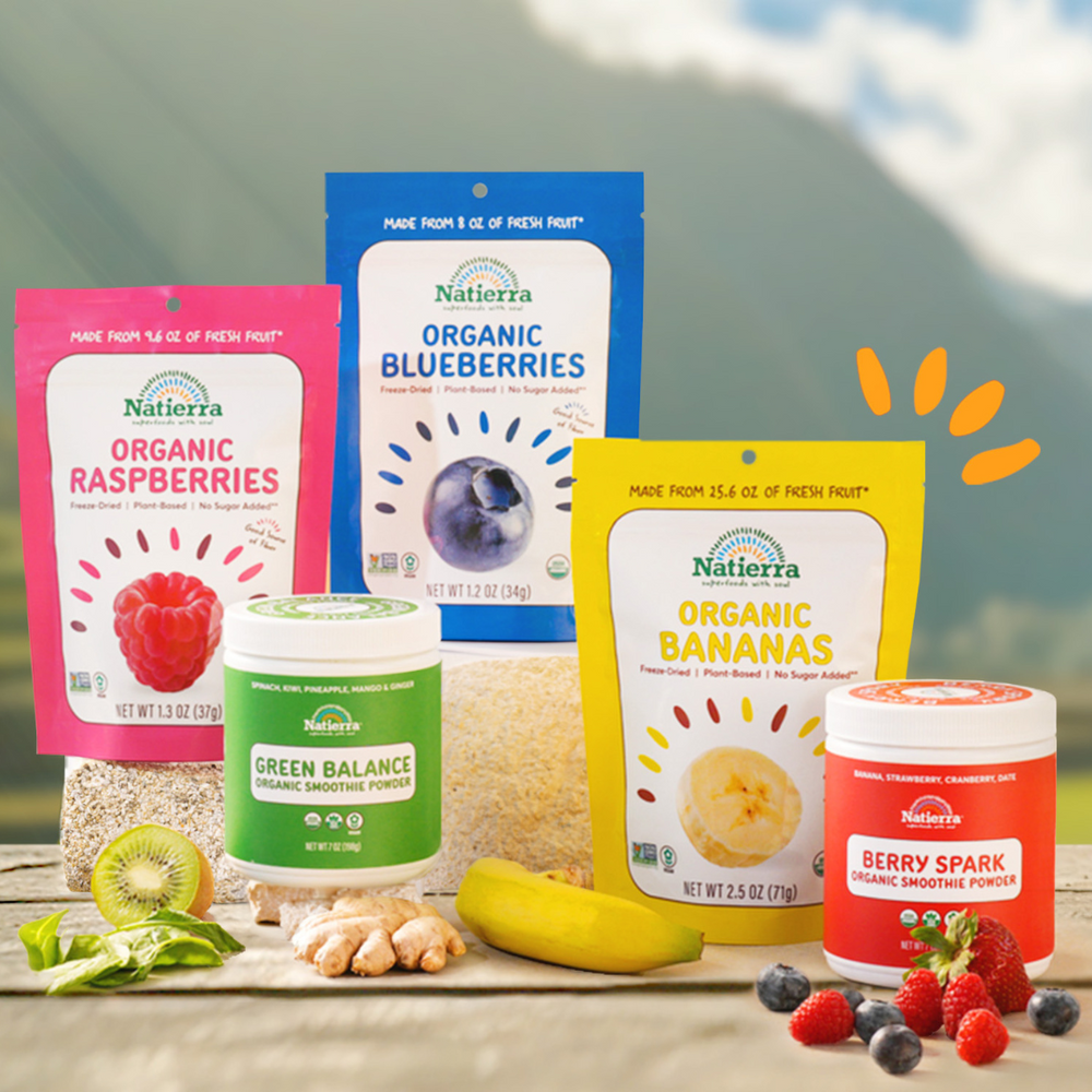 Line up of organic blueberries, raspberries and bananas snack bags and Green Balance and Berry Spark smoothie jars