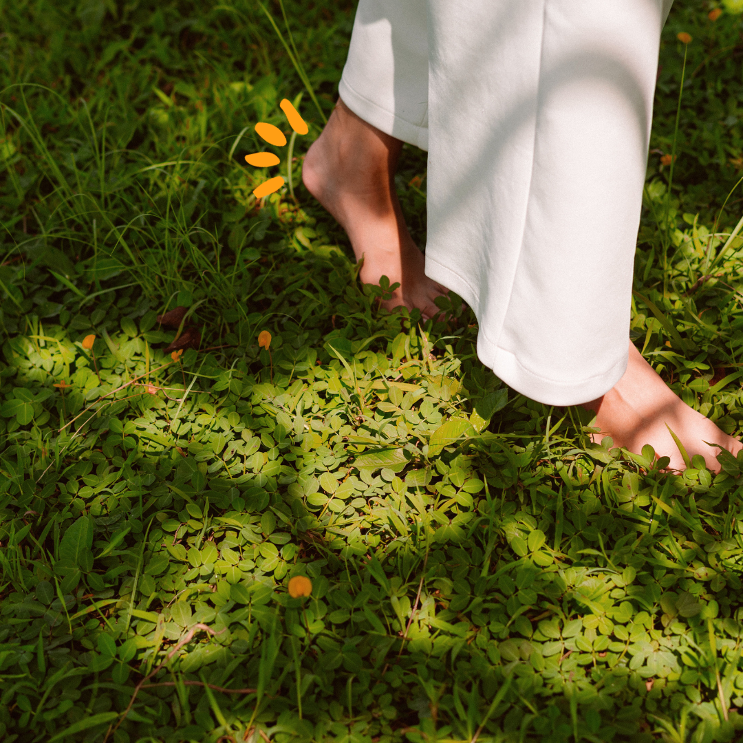 Person walking on the grass barefoot