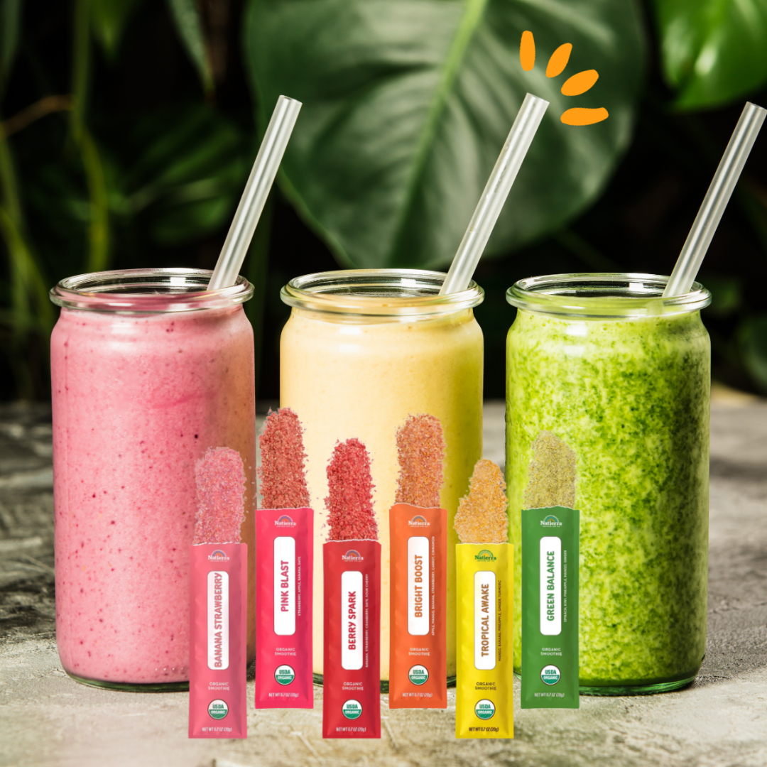Glasses of smoothie liquid with smoothie packets in from of them