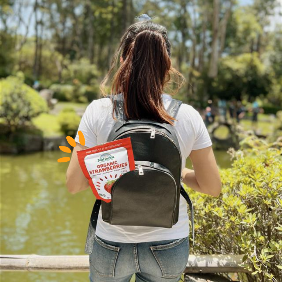 A girl hiking with a backpack that has freeze-dried in it