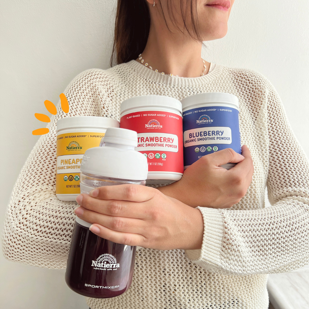 Woman carrying jars of single powder smoothie fruits and a shaker