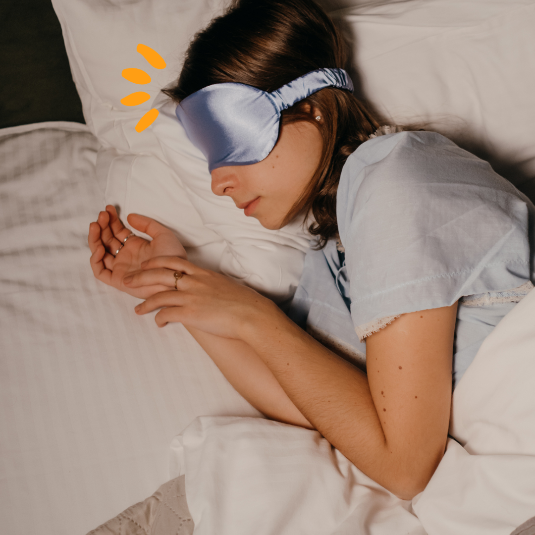Woman sleeping on her side with an eye mask on