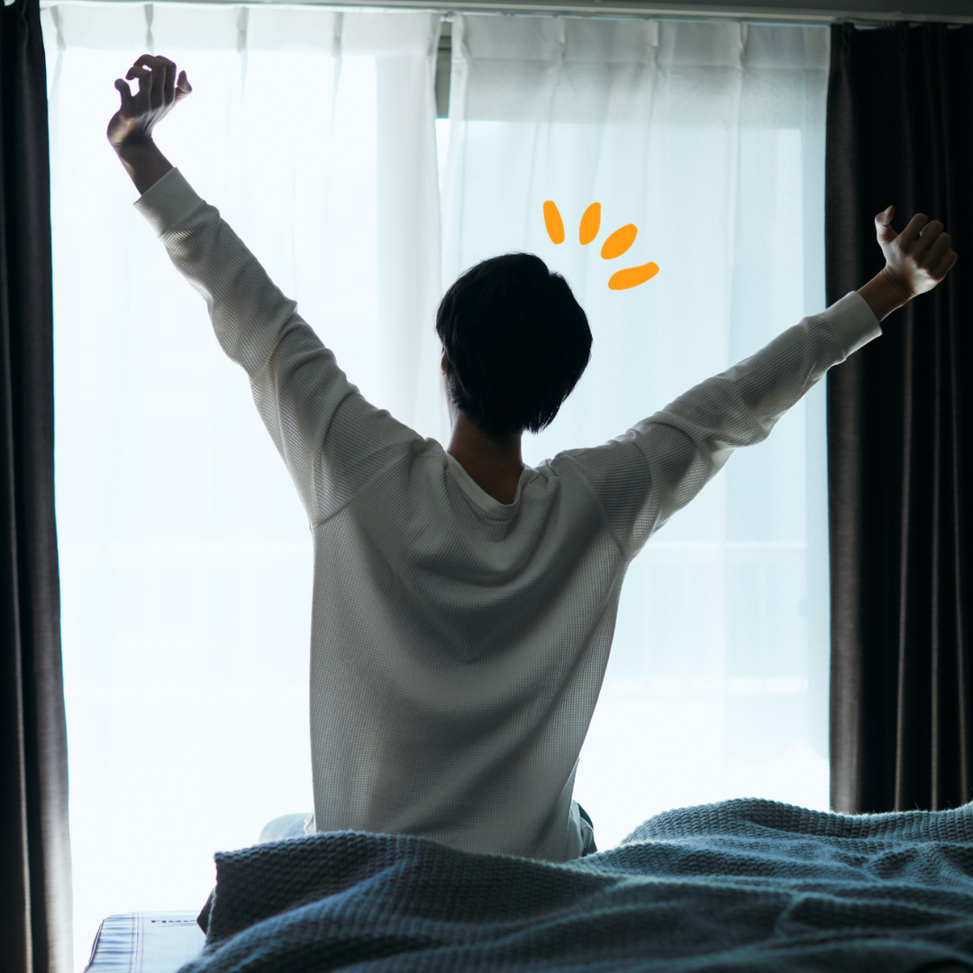 Man stretching in front of a window