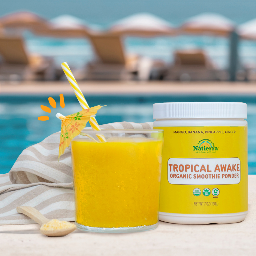 Tropical Awake Smoothie in a glass wtih a cocktail umbrella