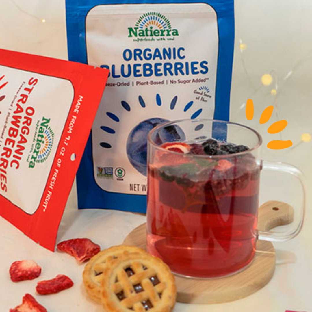 A cup of tea made with organic strawberries and blueberries